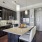 a kitchen with a bar and chairs