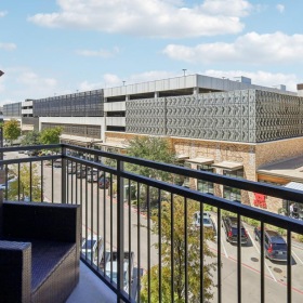 Spacious balconies a building with a glass fence